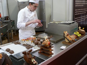 Chocolatier assembling chocolate egg